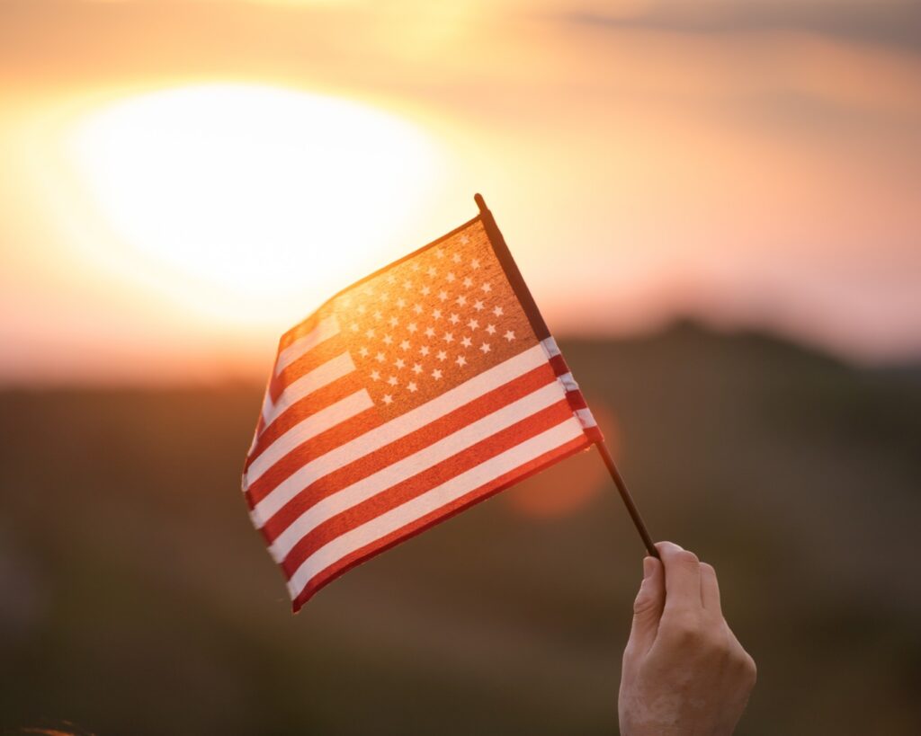 Recipient of EB-3 visa waves a U.S. flag